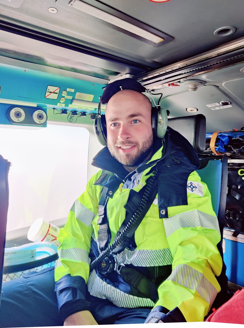 Image shows RAF medic wearing headset and high visibility jacket inside an ambulance.